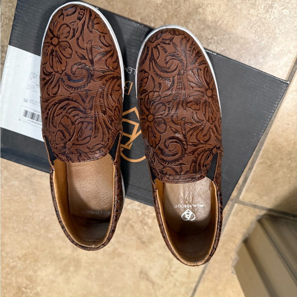 Tooled leather slip on sneakers.